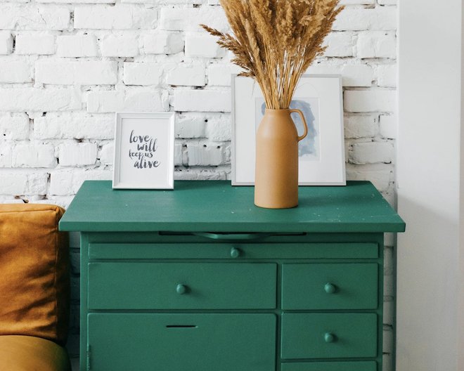 Furniture with green vase